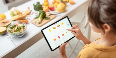 woman holding tablet browing online grocery app